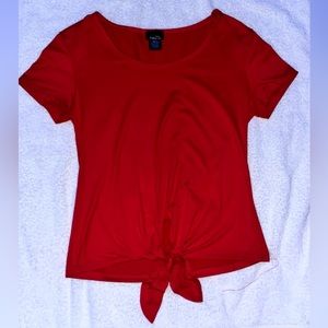 Red silky T-shirt with tie at the bottom.